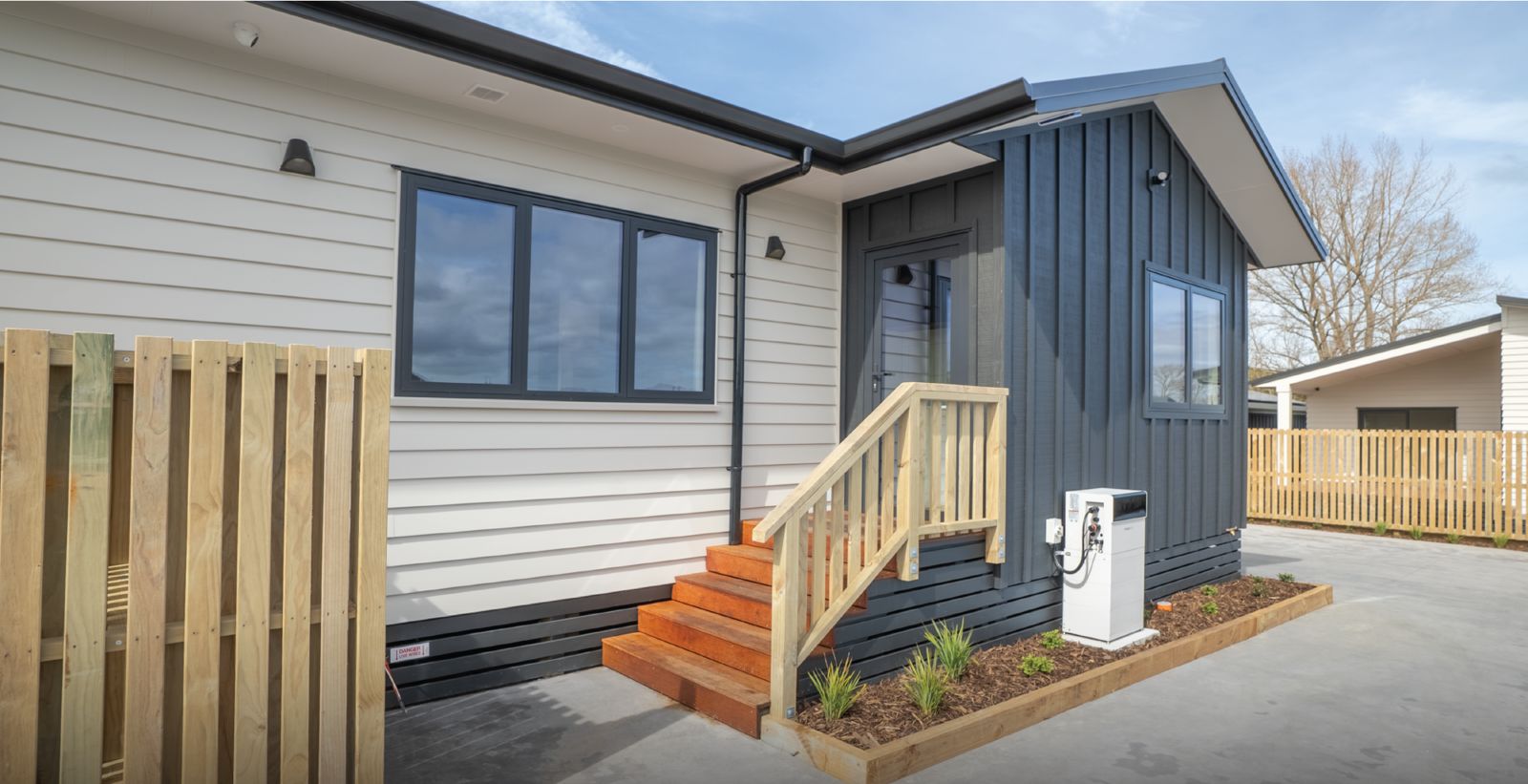 Front entry of a new home with timber steps